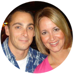 A smiling couple in blue stripe shits and pink blouse