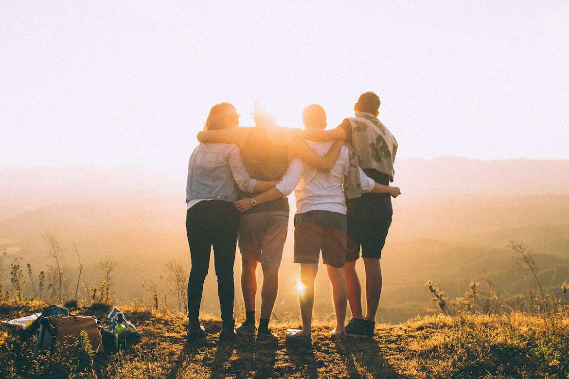 a group of people standing on top of a hill