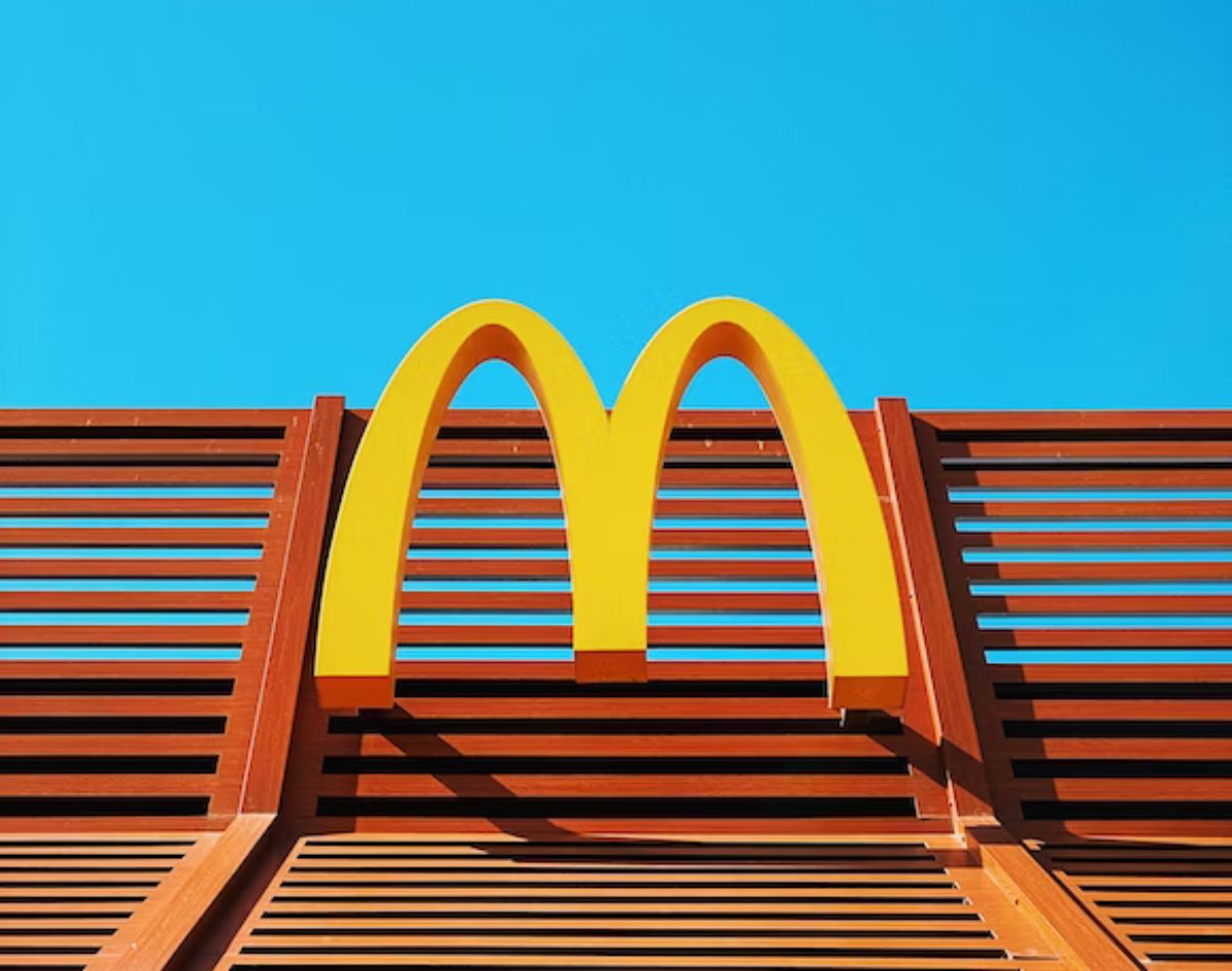 a wooden bench with a mcdonald's logo on it