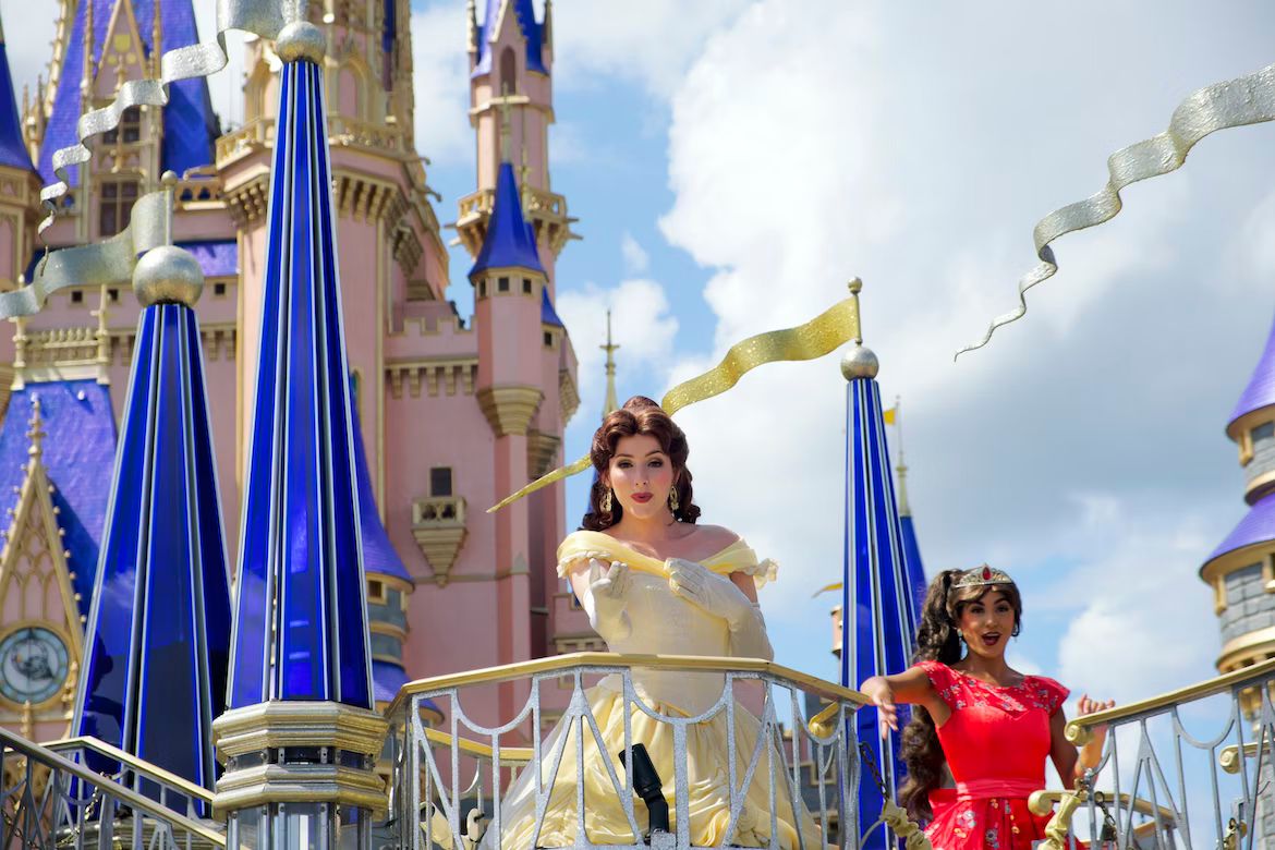 a couple of women standing on top of a balcony next to a castle